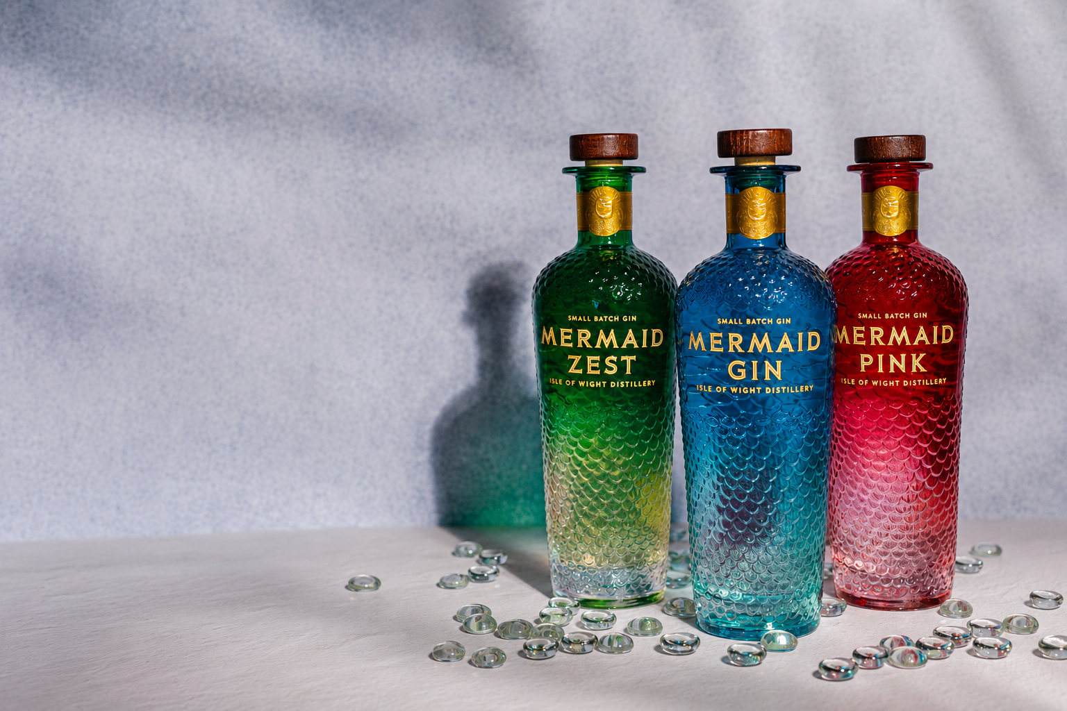 3 bottles of Mermaid Gin - green, blue and pink