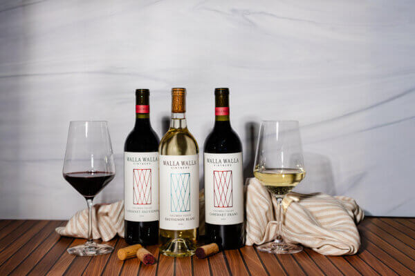 Image of 3 Walla Walla wine bottles with two wine glasses filled