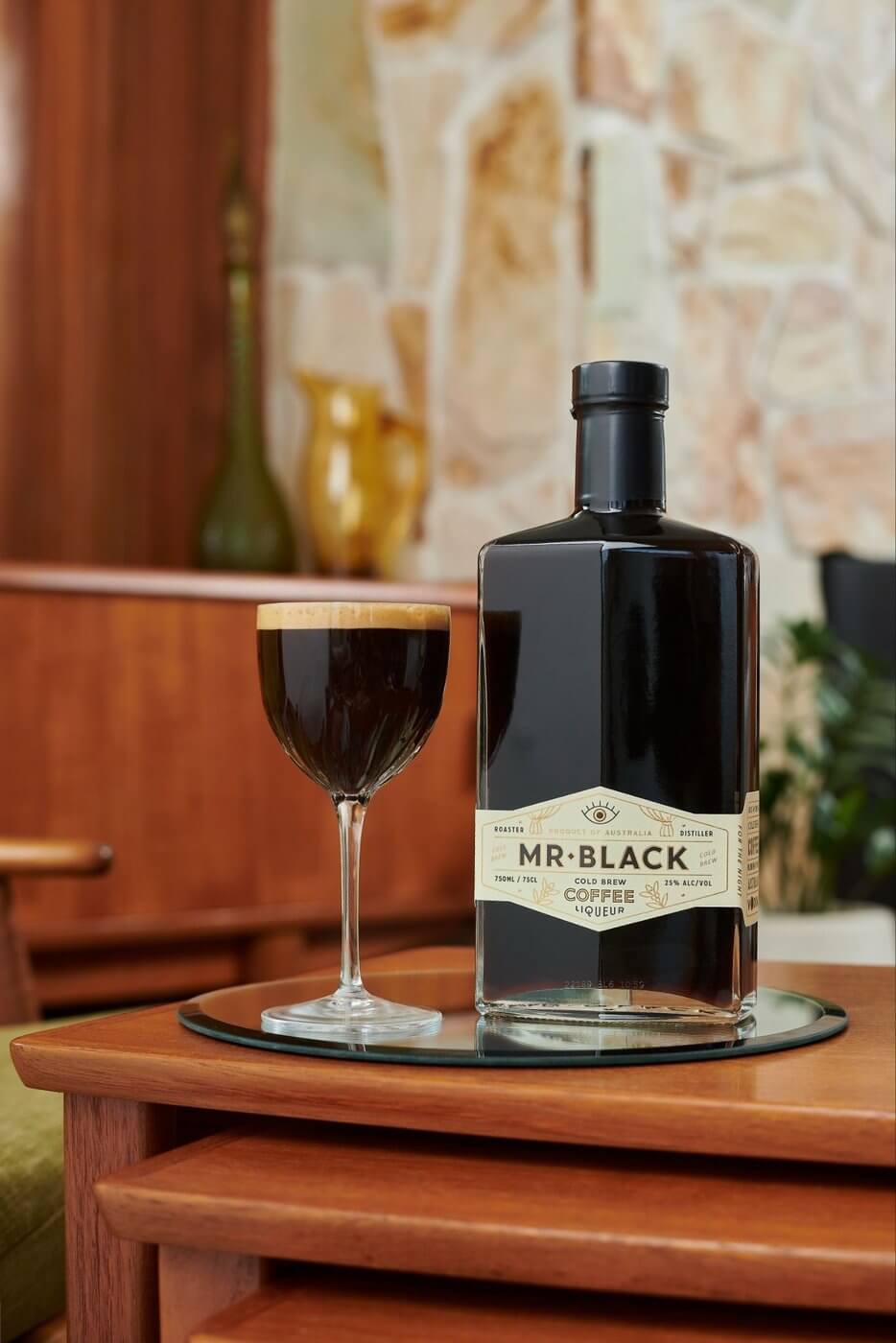 Bottle of Mr. Black cold brew coffee liqueur and glass filled up