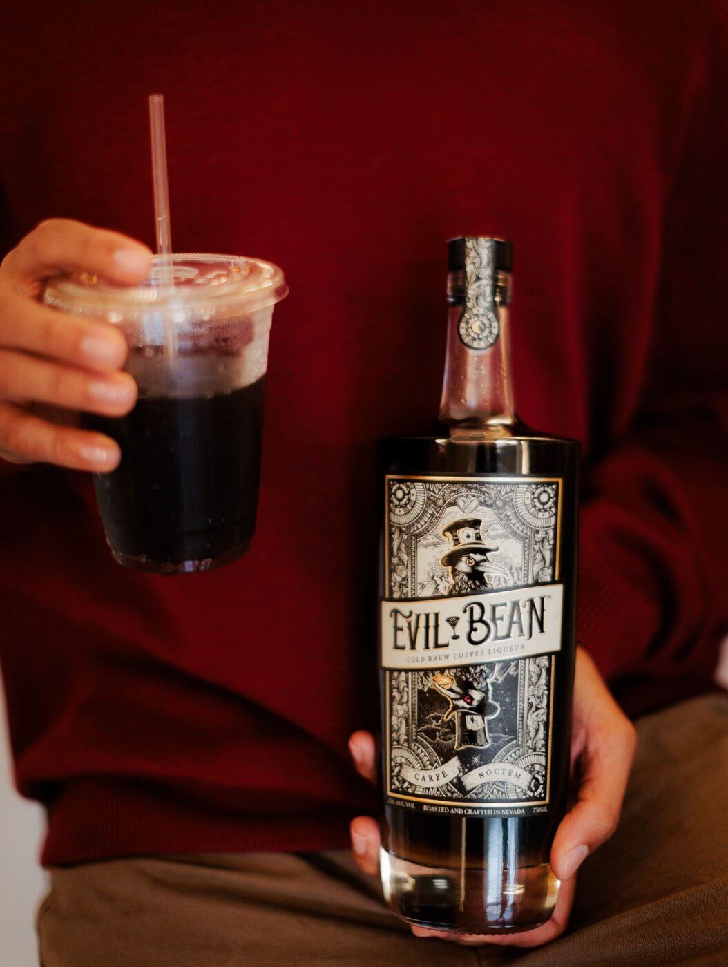 Bottle of Evil Bean cold brew coffee liqueur and coffee cup full