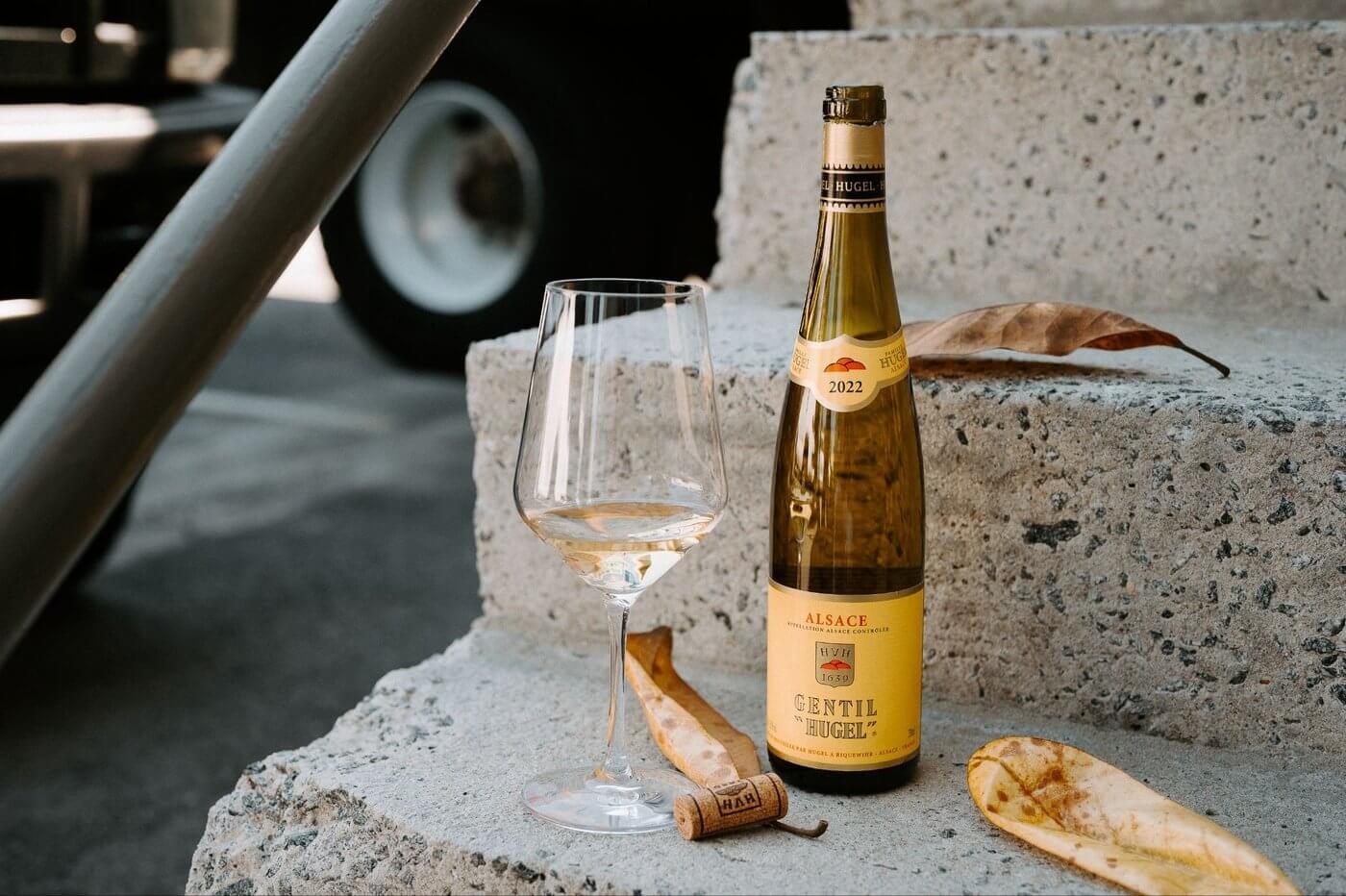 Hugel Gentil wine bottle with wine glass